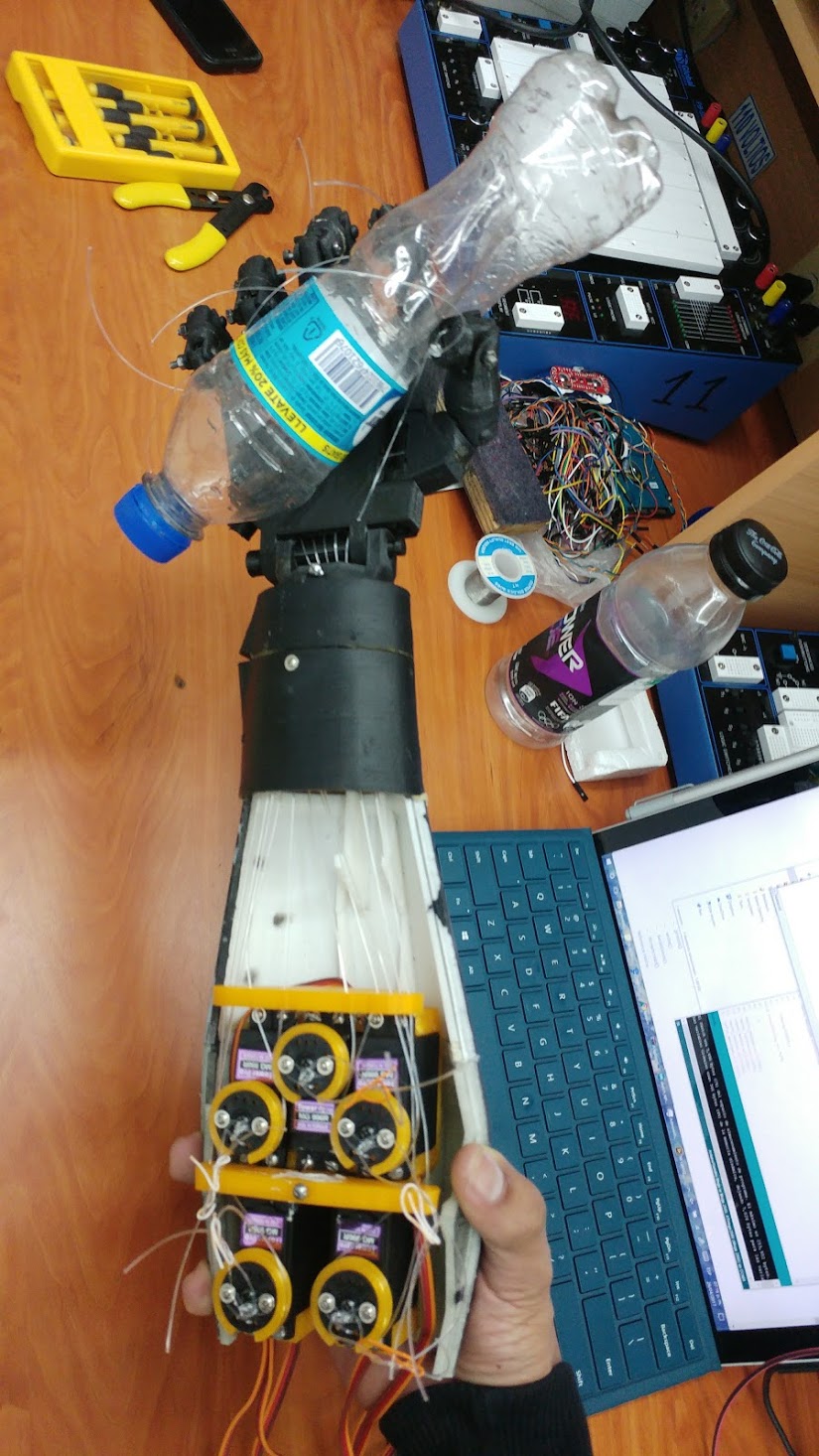 Arm prototype and EMG sensor connected to a user for testing.